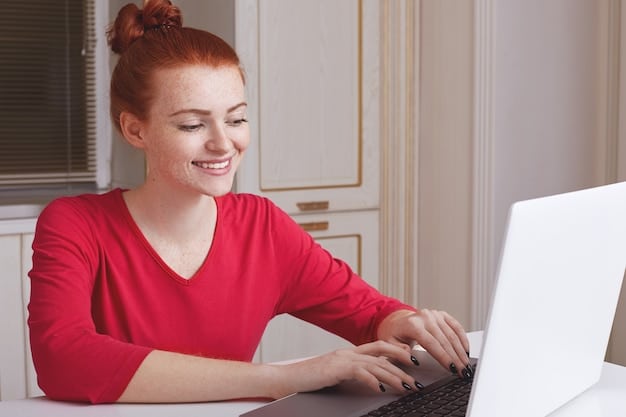 A close-up shot of a young woman smiling confidently while typing on a laptop. The background is blurred, but suggests a comfortable and personalized workspace. The focus is on her positive expression and her hands actively engaged with the keyboard, symbolizing productivity and self-expression.