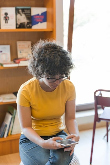 A close-up shot of a student using assistive technology, such as a screen reader, at a computer in a college library.