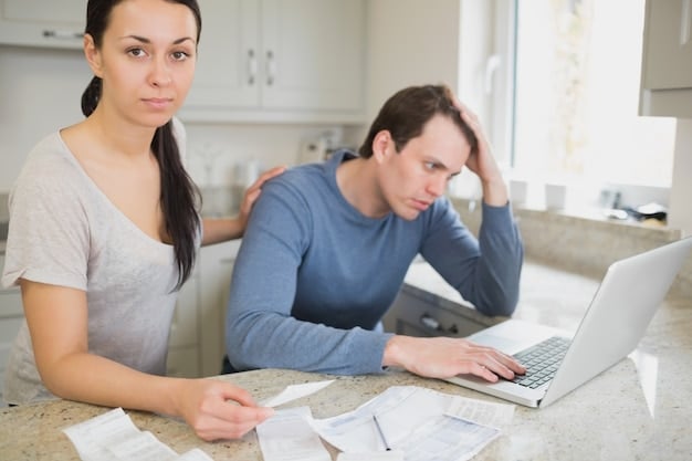 A worried couple sitting at their kitchen table, looking at bills and financial statements, with a laptop displaying a stock market chart showing a sharp decline.