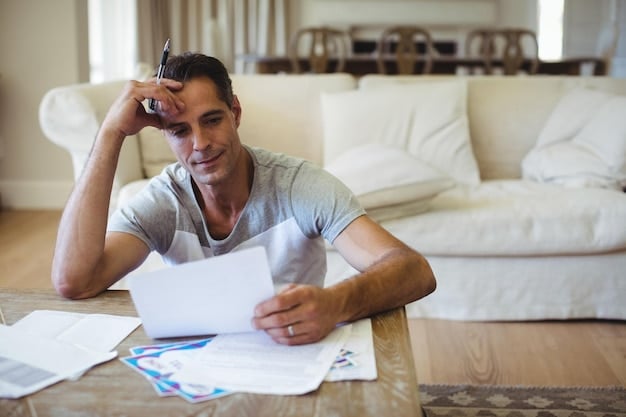 A person looking worriedly at a stack of bills, representing the stress and potential risks associated with taking on a new loan with unfavorable terms.