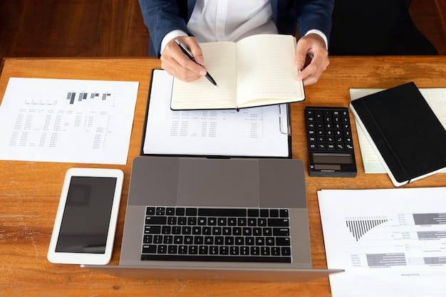 A person completing an online application form for an IDR plan on a laptop, with various financial documents and a calculator scattered on the desk.