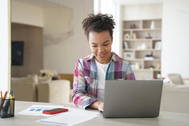 A person sitting at a desk, using a laptop to compare different student loan refinance offers from various lenders.