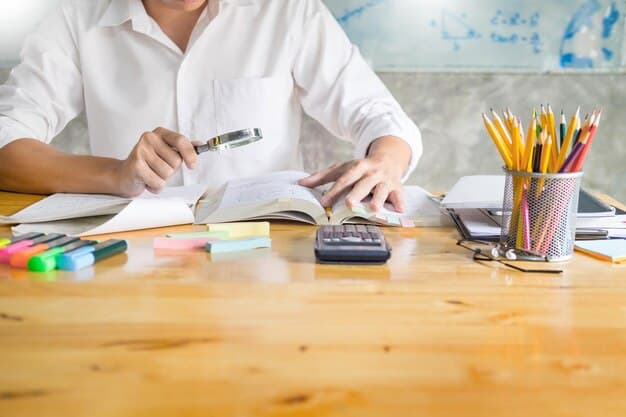 A close-up shot of a teacher's hands filling out a student loan forgiveness application form, with a calculator and pen visible on the desk.