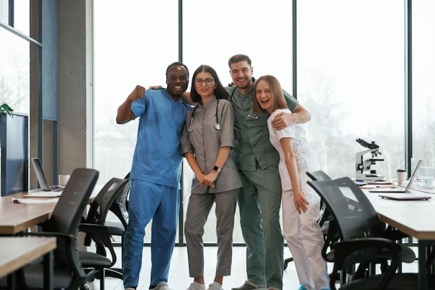 A group of nurses in scrubs standing together, smiling and celebrating. The background shows a modern hospital lobby with natural light.