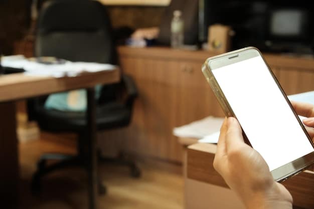 A hand holding a smartphone displaying a fake Social Security Administration notification with a warning sign. The background shows a blurred office setting.