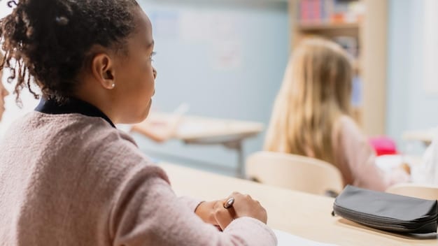 A close-up shot of a teacher providing one-on-one assistance to a student in a classroom. The teacher is smiling and engaged, demonstrating the personal connection and dedication required in the profession.