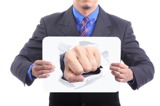 A hand pointing at an error highlighted on a credit report document, symbolizing the act of identifying inaccuracies for dispute.