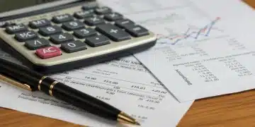 Calculator, Social Security statement, and pen on desk