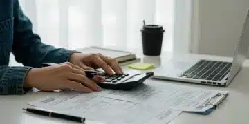 Person analyzing tax forms and calculator for student loan interest deductions