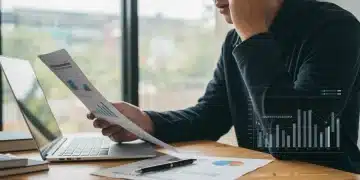 Relieved student loan borrower reviewing IDR plan updates on laptop